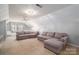 Spacious bonus room with sectional sofa and built-in shelves at 517 Stuart Ridge None, Cramerton, NC 28032