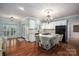 Open kitchen with island, white cabinetry, and hardwood floors at 517 Stuart Ridge None, Cramerton, NC 28032