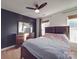 Simple bedroom with a double bed, dresser, and ceiling fan at 5229 Mt Holly Huntersville Rd, Charlotte, NC 28216