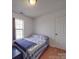 Cozy bedroom with a double bed and large window at 5229 Mt Holly Huntersville Rd, Charlotte, NC 28216