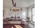 Rustic dining room with a long wooden table and chandelier at 5229 Mt Holly Huntersville Rd, Charlotte, NC 28216