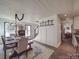 Elegant dining room with a rustic wooden table, stylish chairs, and modern lighting at 5229 Mt Holly Huntersville Rd, Charlotte, NC 28216