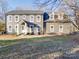 Inviting two-story gray home with white trim, a covered entryway, and a lush green lawn at 5229 Mt Holly Huntersville Rd, Charlotte, NC 28216