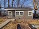 Charming gray cottage with a covered porch and well-manicured lawn at 5229 Mt Holly Huntersville Rd, Charlotte, NC 28216