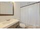 Clean bathroom with a white vanity, shower/tub combo, and wood-look flooring at 533 Wakefield Dr # B, Charlotte, NC 28209