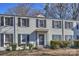 Brick building with gray shutters, a black door, and well-manicured hedges at 533 Wakefield Dr # B, Charlotte, NC 28209