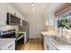 Modern kitchen with white cabinets, stainless steel appliances, and marble countertops at 533 Wakefield Dr # B, Charlotte, NC 28209