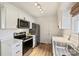 Modern kitchen with white cabinets, stainless steel appliances, and marble countertops at 533 Wakefield Dr # B, Charlotte, NC 28209