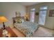 Bedroom with floral bedding and French doors at 5424 Amanda Ln, Belmont, NC 28012