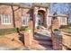 Brick walkway leading to a grand entryway with detailed columns and landscaping at 5424 Amanda Ln, Belmont, NC 28012