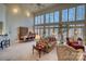 High-ceilinged living area with hardwood floors, multiple seating areas, and wall of windows at 5424 Amanda Ln, Belmont, NC 28012