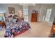 Main bedroom with floral bedding and a view of the en-suite bathroom at 5424 Amanda Ln, Belmont, NC 28012