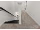 Modern staircase with black railings and neutral carpeting at 576 Station St # 28, Clover, SC 29710