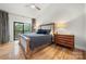 Main bedroom with wood floors, sliding door to balcony, and wood bed frame at 59 Ridgeport Rd, Clover, SC 29710