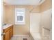 Bathroom with tub, sink, and wood vanity at 6208 Karenstone Dr, Charlotte, NC 28215