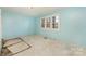 Light blue walls and large window in this bedroom at 6208 Karenstone Dr, Charlotte, NC 28215