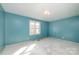 Light blue walls and a window in this bedroom at 6208 Karenstone Dr, Charlotte, NC 28215