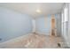 Simple bedroom with light blue walls and two windows at 6208 Karenstone Dr, Charlotte, NC 28215