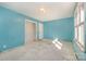 Empty bedroom with light blue walls and a closet at 6208 Karenstone Dr, Charlotte, NC 28215