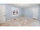 Bedroom with light blue walls and window view at 6208 Karenstone Dr, Charlotte, NC 28215