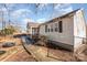 Backyard view with a basketball hoop and tire swing at 6208 Karenstone Dr, Charlotte, NC 28215