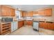 View of kitchen with wood cabinets and appliances at 6208 Karenstone Dr, Charlotte, NC 28215