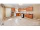 Wood cabinets and appliances in this kitchen at 6208 Karenstone Dr, Charlotte, NC 28215