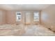 Empty living room with damaged flooring and walls at 6208 Karenstone Dr, Charlotte, NC 28215