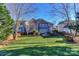 Spacious backyard showcasing a large home and trees at 626 Lorain Nw Ave, Concord, NC 28027