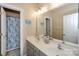 Bathroom boasts double sinks, a shower, and updated vanity at 626 Lorain Nw Ave, Concord, NC 28027