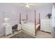 Bright bedroom with a post bed, built-in shelves, and a small workspace at 626 Lorain Nw Ave, Concord, NC 28027