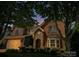 Inviting brick home at dusk, featuring stone accents, manicured landscaping, and a warm, welcoming ambiance at 626 Lorain Nw Ave, Concord, NC 28027