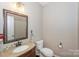 Small powder room with toilet and vanity at 626 Lorain Nw Ave, Concord, NC 28027