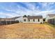 Large backyard with a grassy area and wooden fence at 6603 Wandering Creek Dr, Charlotte, NC 28216