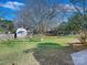 Large backyard with shed and open grassy area at 6633 Old Reid Rd, Charlotte, NC 28210