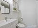 Clean bathroom with white vanity and floating shelves at 6633 Old Reid Rd, Charlotte, NC 28210