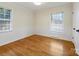 Bright bedroom with hardwood floors and window coverings at 6633 Old Reid Rd, Charlotte, NC 28210