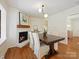 Dining room featuring a fireplace, hardwood floors, and a wood table at 6633 Old Reid Rd, Charlotte, NC 28210