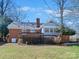 Brick house with a deck and sunroom addition at 6633 Old Reid Rd, Charlotte, NC 28210