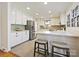 Bright kitchen with white cabinets, stainless steel appliances, and quartz countertops at 6633 Old Reid Rd, Charlotte, NC 28210