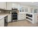 Updated kitchen boasts stainless steel appliances and stylish gray backsplash at 6633 Old Reid Rd, Charlotte, NC 28210