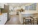 Modern kitchen with white cabinets, a breakfast bar, and stainless steel appliances at 6633 Old Reid Rd, Charlotte, NC 28210