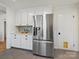 Sleek kitchen with stainless steel refrigerator and white shaker cabinets at 6633 Old Reid Rd, Charlotte, NC 28210