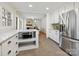 Modern kitchen features white cabinets, stainless steel appliances, and an island at 6633 Old Reid Rd, Charlotte, NC 28210