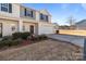 Two-story townhome with attached garage and landscaping at 8138 Paw Club Dr, Charlotte, NC 28214