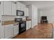 Modern kitchen with black appliances and white cabinets at 8138 Paw Club Dr, Charlotte, NC 28214