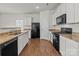 Kitchen boasts granite countertops and white cabinets at 8138 Paw Club Dr, Charlotte, NC 28214