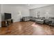 Spacious living room with grey sectional sofa and hardwood floors at 8138 Paw Club Dr, Charlotte, NC 28214