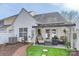 Outdoor patio area with comfortable seating, a pergola, lush turf, and views of the home's facade at 8636 Robinson Forest Dr, Charlotte, NC 28277