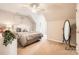 Calming bedroom featuring neutral walls and carpet and a decorative floor mirror at 8636 Robinson Forest Dr, Charlotte, NC 28277